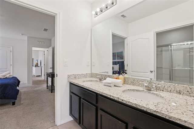 7033 Oakwood St, Davenport, FL 33837 - ensuite bathroom featuring double vanity, an enclosed shower, and baseboards