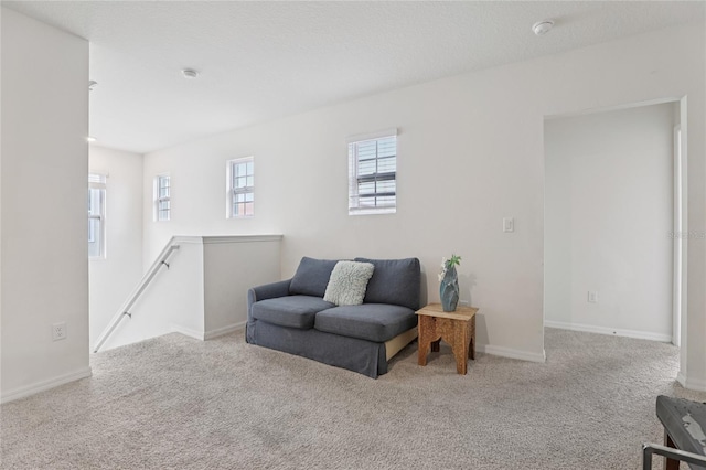 7033 Oakwood St, Davenport, FL 33837 - sitting room featuring an upstairs landing, carpet floors, and baseboards