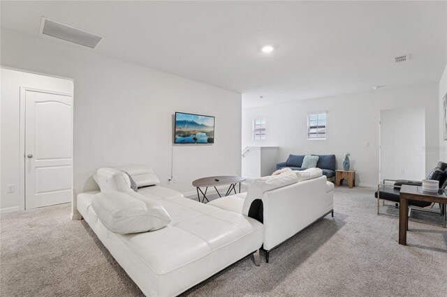 7033 Oakwood St, Davenport, FL 33837 - living room featuring light colored carpet, baseboards, and recessed lighting