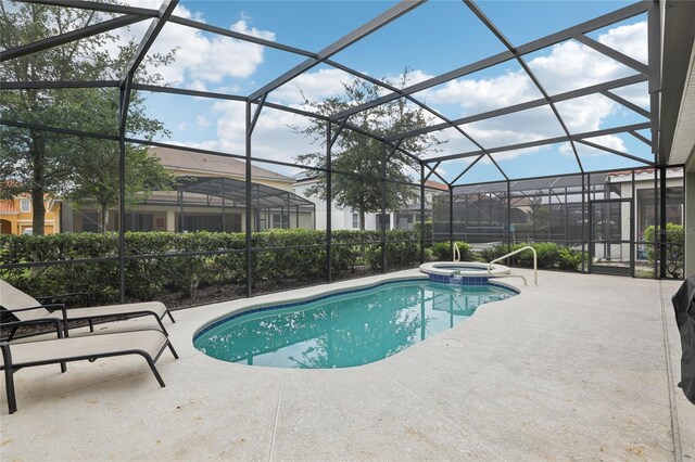 7033 Oakwood St, Davenport, FL 33837 - view of swimming pool featuring a patio, a pool with connected hot tub, and glass enclosure