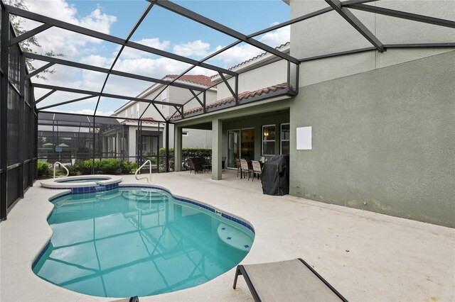 7033 Oakwood St, Davenport, FL 33837 - view of pool with a patio area, a pool with connected hot tub, and glass enclosure