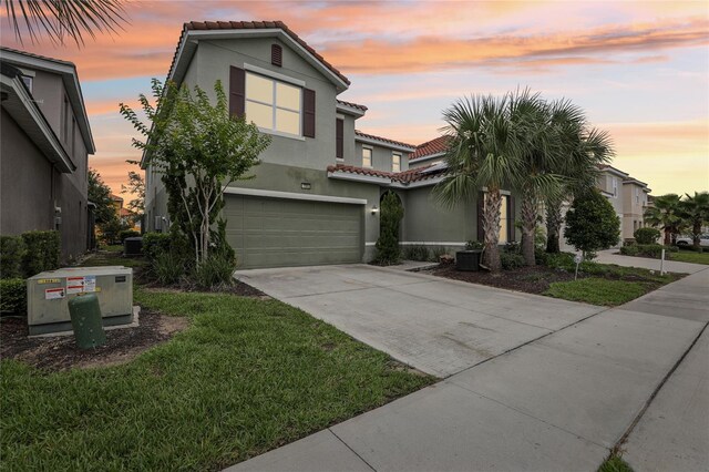 7033 Oakwood St, Davenport, FL 33837 - mediterranean / spanish-style house featuring a tile roof, stucco siding, and concrete driveway