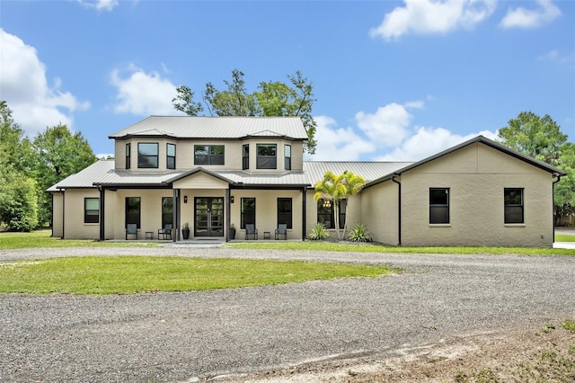 2459 Mcgregor Oaks Ln, Deland, FL 32720 - modern farmhouse style home with french doors, stucco siding, metal roof, and a front yard