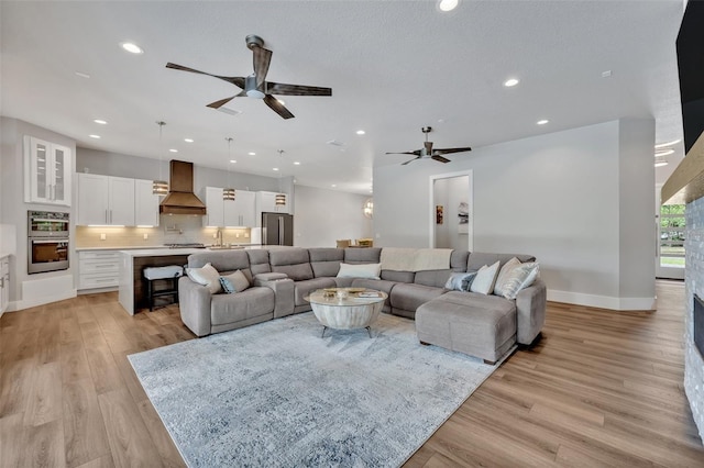 2459 Mcgregor Oaks Ln, Deland, FL 32720 - living room with ceiling fan, light wood-style floors, recessed lighting, and baseboards