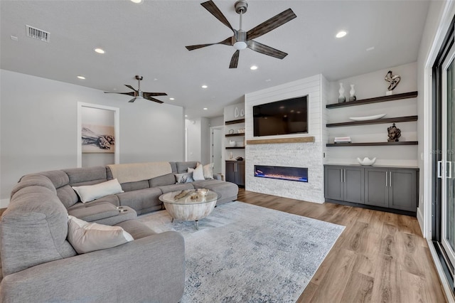 2459 Mcgregor Oaks Ln, Deland, FL 32720 - living area featuring ceiling fan, light wood-style flooring, a fireplace, and recessed lighting