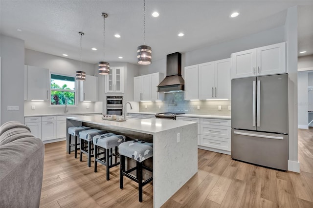 2459 Mcgregor Oaks Ln, Deland, FL 32720 - kitchen with appliances with stainless steel finishes, custom exhaust hood, light countertops, tasteful backsplash, and a kitchen breakfast bar