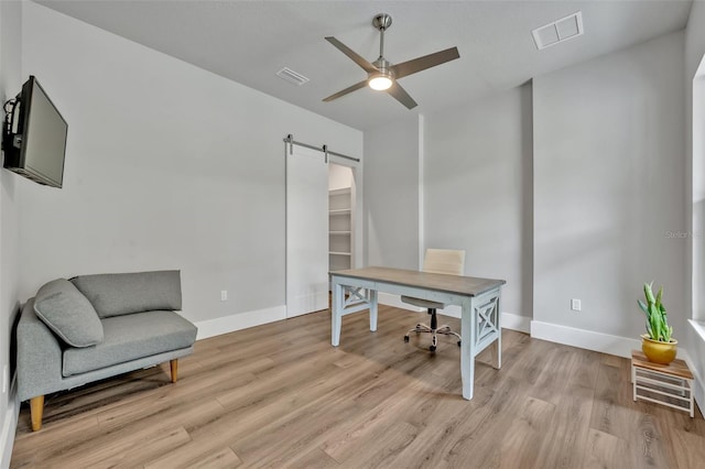 2459 Mcgregor Oaks Ln, Deland, FL 32720 - office with a barn door, a ceiling fan, light wood-style floors, and baseboards