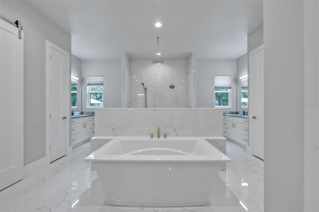 2459 Mcgregor Oaks Ln, Deland, FL 32720 - bathroom with marble tiled floors, a freestanding tub, vanity, a marble finish shower, and recessed lighting