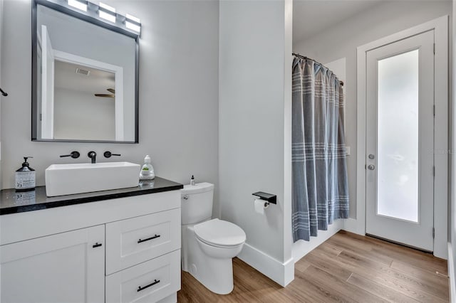 2459 Mcgregor Oaks Ln, Deland, FL 32720 - bathroom featuring wood finished floors, vanity, toilet, and baseboards