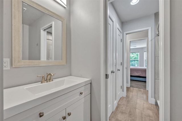 2459 Mcgregor Oaks Ln, Deland, FL 32720 - ensuite bathroom featuring vanity, wood finished floors, and baseboards