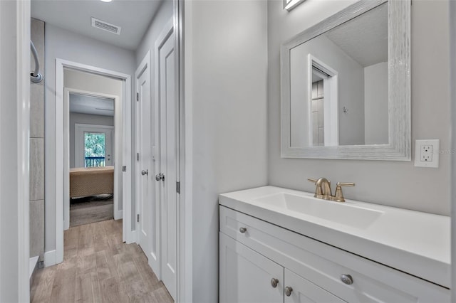 2459 Mcgregor Oaks Ln, Deland, FL 32720 - bathroom featuring vanity, wood finished floors, and baseboards