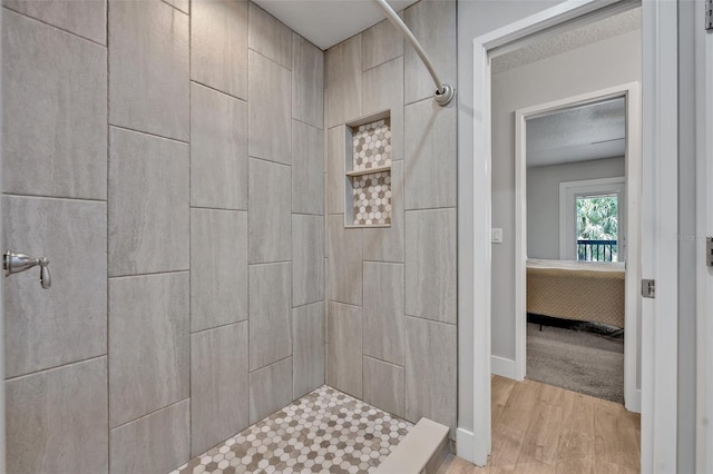 2459 Mcgregor Oaks Ln, Deland, FL 32720 - bathroom with tiled shower, wood finished floors, and a textured ceiling