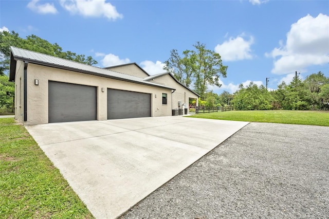 2459 Mcgregor Oaks Ln, Deland, FL 32720 - view of side of home featuring concrete driveway, stucco siding, a garage, and metal roof
