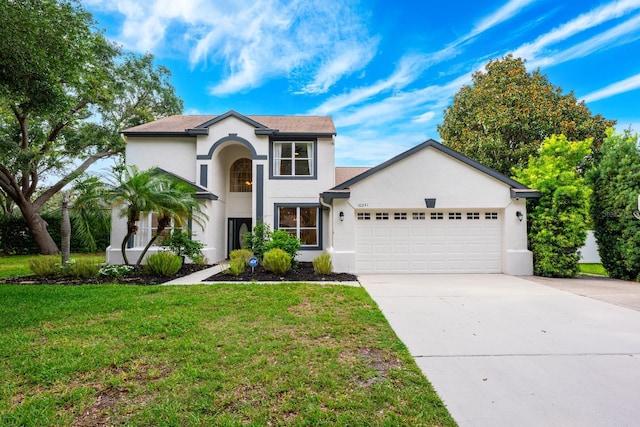 10241 Pointview Ct, Orlando, FL 32836 - view of front of property with stucco siding, a garage, driveway, and a front lawn
