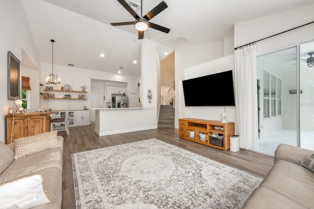 10241 Pointview Ct, Orlando, FL 32836 - living area featuring a ceiling fan, wood finished floors, a chandelier, stairway, and baseboards