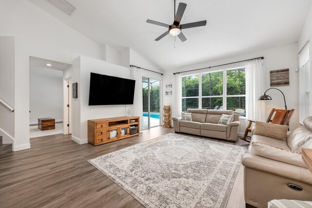 10241 Pointview Ct, Orlando, FL 32836 - living room with lofted ceiling, wood finished floors, a ceiling fan, stairs, and baseboards