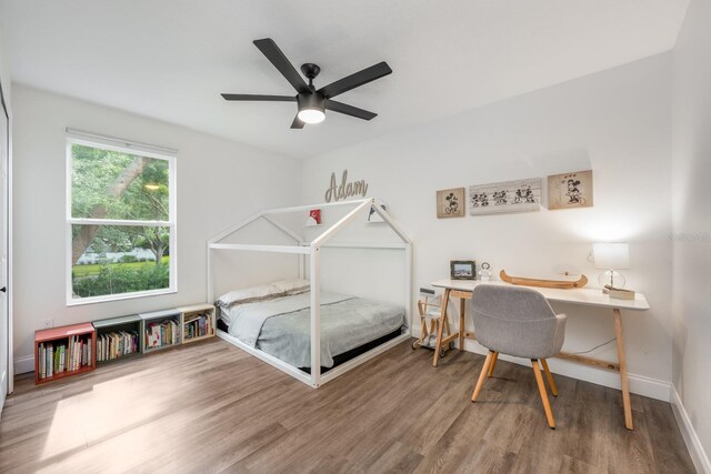 10241 Pointview Ct, Orlando, FL 32836 - bedroom with wood finished floors, baseboards, a ceiling fan, and a desk