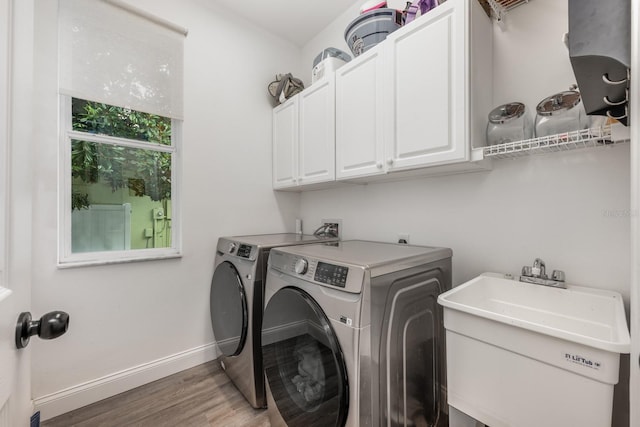 10241 Pointview Ct, Orlando, FL 32836 - washroom featuring cabinet space, independent washer and dryer, wood finished floors, and baseboards