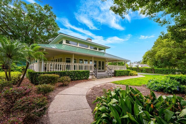 10241 Pointview Ct, Orlando, FL 32836 - farmhouse-style home featuring a porch, metal roof, french doors, and a chimney