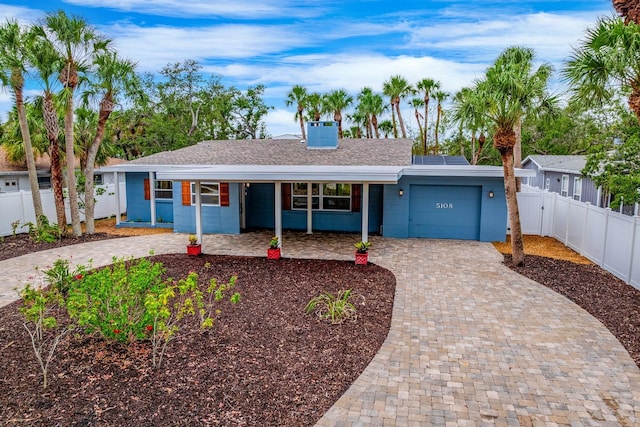 5108 Saint Albans Ave, Siesta Key, FL 34242 - ranch-style home with decorative driveway, a garage, a porch, and roof with shingles