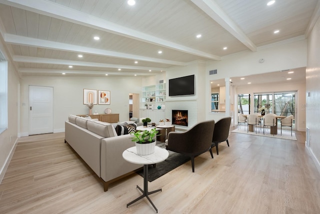 5108 Saint Albans Ave, Siesta Key, FL 34242 - living room featuring a lit fireplace, light wood-style floors, baseboards, recessed lighting, and beamed ceiling