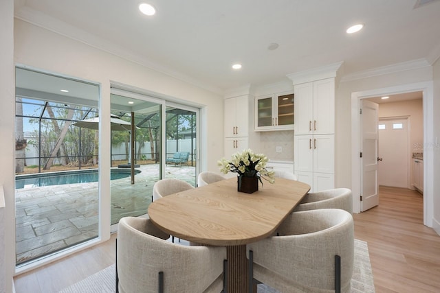 5108 Saint Albans Ave, Siesta Key, FL 34242 - dining area with ornamental molding, healthy amount of natural light, light wood finished floors, and recessed lighting