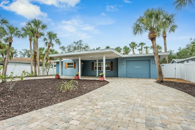 5108 Saint Albans Ave, Siesta Key, FL 34242 - view of front of home with a garage, decorative driveway, covered porch, and a gate