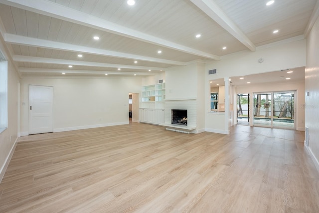 5108 Saint Albans Ave, Siesta Key, FL 34242 - unfurnished living room with baseboards, light wood-style floors, beam ceiling, recessed lighting, and a brick fireplace