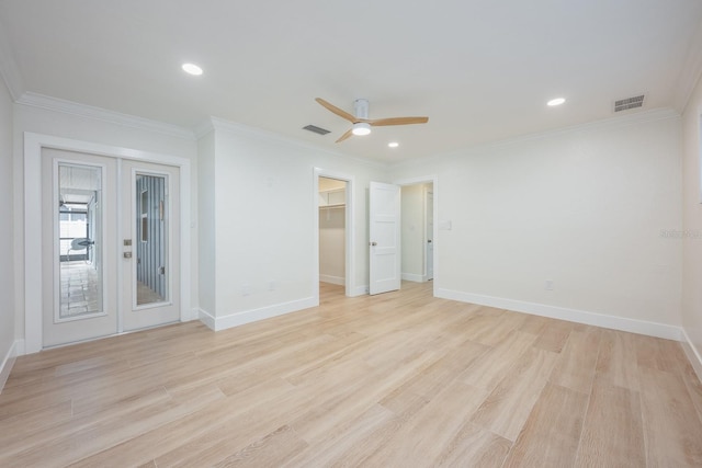 5108 Saint Albans Ave, Siesta Key, FL 34242 - unfurnished bedroom with french doors, ornamental molding, light wood-type flooring, baseboards, and a walk in closet