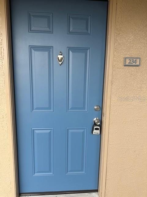 7350 Westpointe Blvd Unit 234, Orlando, FL 32835 - doorway to property featuring stucco siding