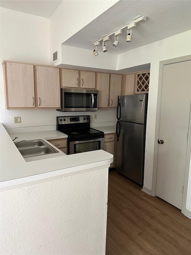 7350 Westpointe Blvd Unit 234, Orlando, FL 32835 - kitchen featuring stainless steel appliances, light brown cabinets, a sink, light countertops, and a peninsula