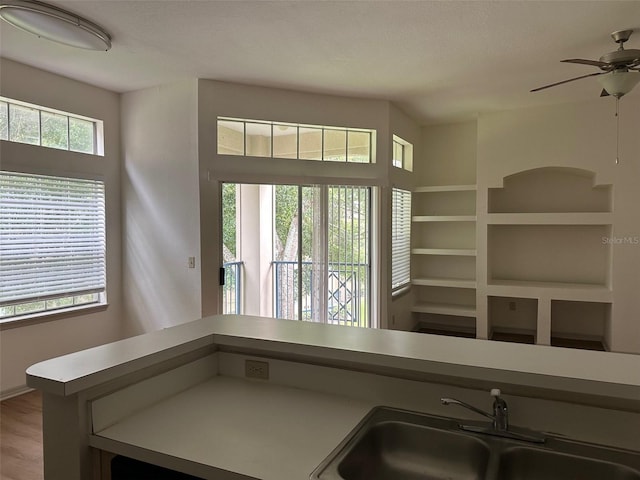 7350 Westpointe Blvd Unit 234, Orlando, FL 32835 - kitchen with a sink, ceiling fan, open floor plan, light countertops, and wood finished floors