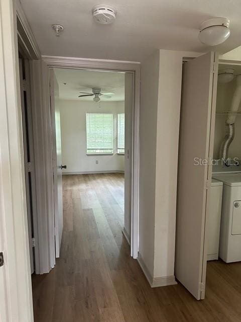 7350 Westpointe Blvd Unit 234, Orlando, FL 32835 - hall with wood finished floors, washing machine and clothes dryer, and baseboards
