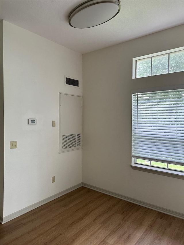 7350 Westpointe Blvd Unit 234, Orlando, FL 32835 - spare room featuring wood finished floors and baseboards