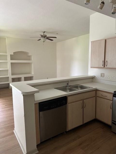 7350 Westpointe Blvd Unit 234, Orlando, FL 32835 - kitchen with appliances with stainless steel finishes, a peninsula, dark wood-style flooring, a sink, and light countertops