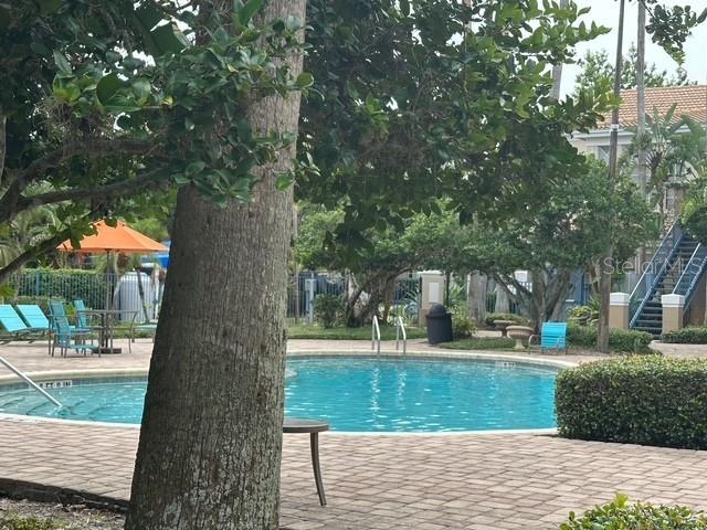 7350 Westpointe Blvd Unit 234, Orlando, FL 32835 - community pool with a patio and stairs