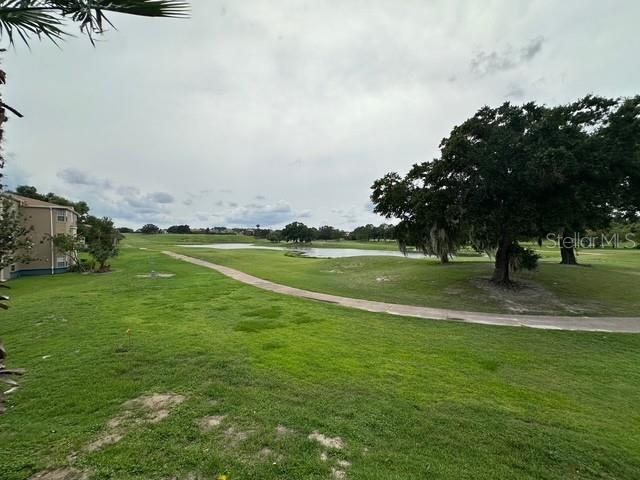 7350 Westpointe Blvd Unit 234, Orlando, FL 32835 - surrounding community featuring a lawn and a water view
