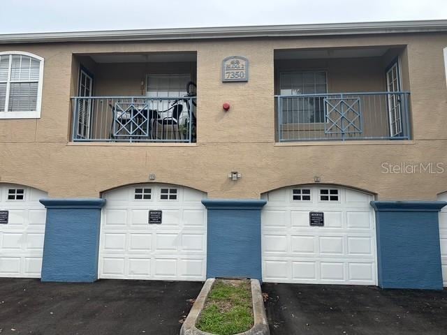 7350 Westpointe Blvd Unit 234, Orlando, FL 32835 - view of building exterior featuring a garage and driveway