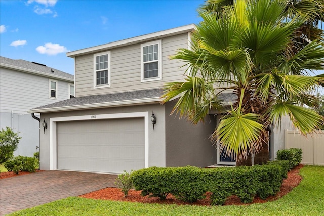 17416 Painted Leaf Way, Clermont, FL 34714 - view of side of home featuring an attached garage, decorative driveway, stucco siding, and roof with shingles