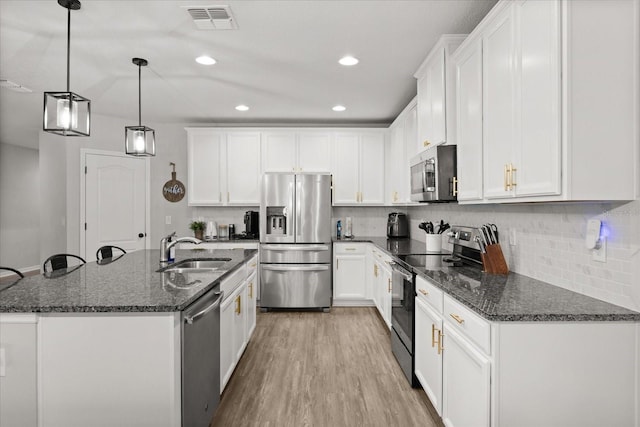 17416 Painted Leaf Way, Clermont, FL 34714 - kitchen featuring appliances with stainless steel finishes, a sink, white cabinets, and recessed lighting