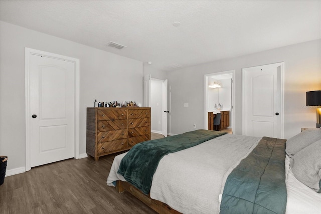 17416 Painted Leaf Way, Clermont, FL 34714 - bedroom featuring wood finished floors, baseboards, and ensuite bath