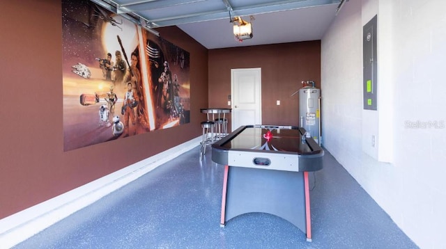 8986 Cabot Cliffs Dr, Davenport, FL 33896 - rec room with water heater, speckle patterned floor, and a garage