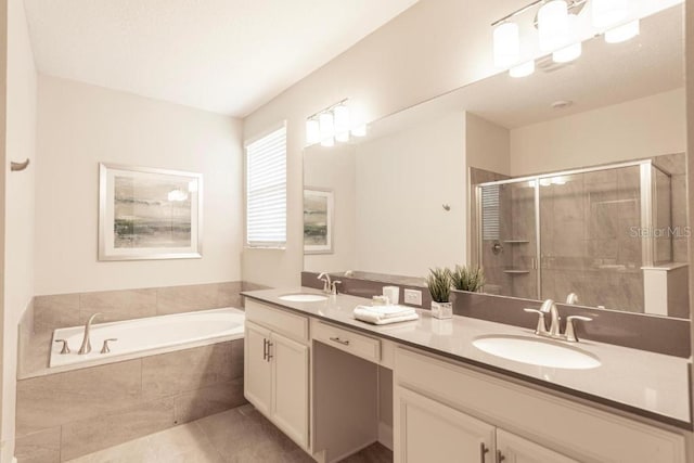 8986 Cabot Cliffs Dr, Davenport, FL 33896 - bathroom with double vanity, a shower stall, a garden tub, and tile patterned flooring