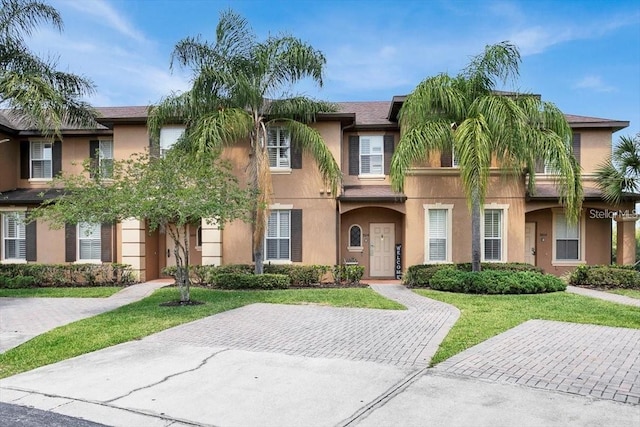 3214 Calabria Ave, Davenport, FL 33897 - townhome / multi-family property featuring stucco siding and a front yard