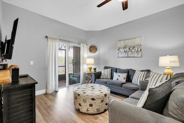 3214 Calabria Ave, Davenport, FL 33897 - living area with a ceiling fan, light wood-style flooring, and baseboards