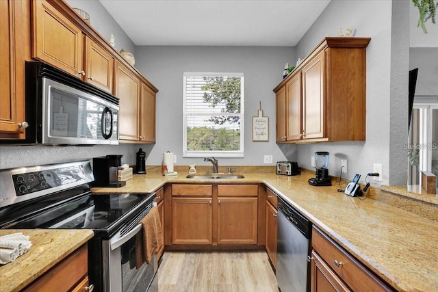 3214 Calabria Ave, Davenport, FL 33897 - kitchen featuring stainless steel appliances, a sink, and brown cabinetry