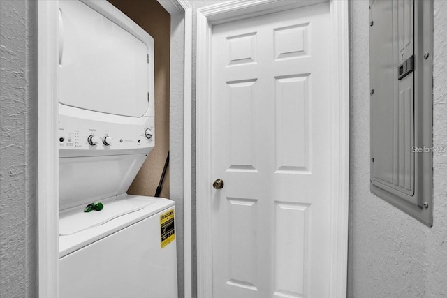 3214 Calabria Ave, Davenport, FL 33897 - laundry area featuring stacked washer and clothes dryer and a textured wall