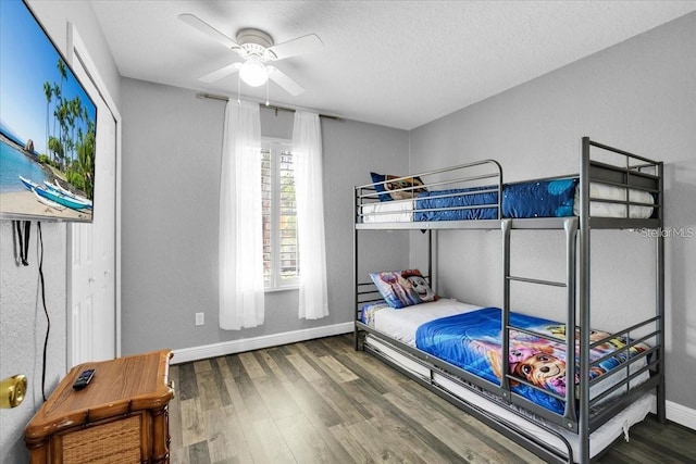 3214 Calabria Ave, Davenport, FL 33897 - bedroom featuring wood finished floors, baseboards, ceiling fan, and a textured ceiling