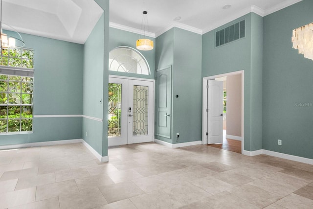 3307 Kentshire Blvd, Ocoee, FL 34761 - tiled foyer entrance with a towering ceiling, crown molding, and baseboards