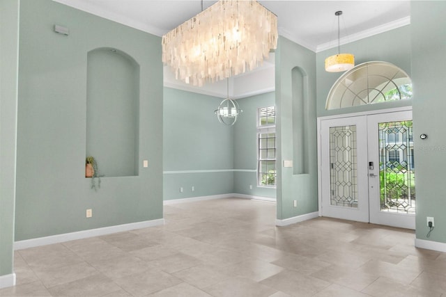 3307 Kentshire Blvd, Ocoee, FL 34761 - foyer featuring a chandelier, crown molding, baseboards, tile patterned flooring, and arched walkways